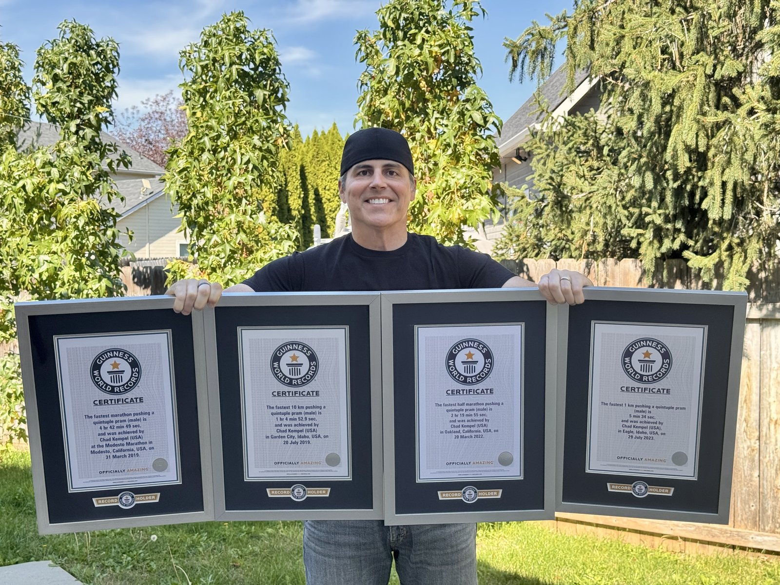 Chad Kempel holding his four framed Guinness World Records certificates side by side