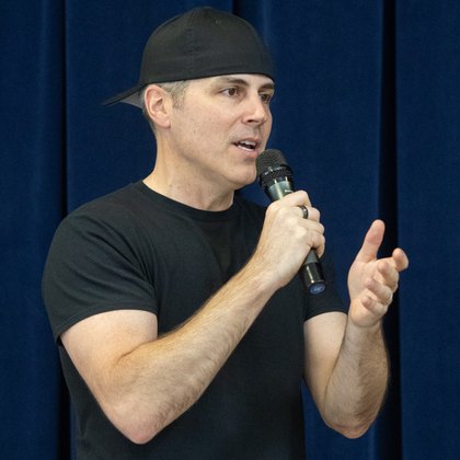 Chad Kempel, keynote and motivational speaker in Boise, Idaho, on stage with a microphone