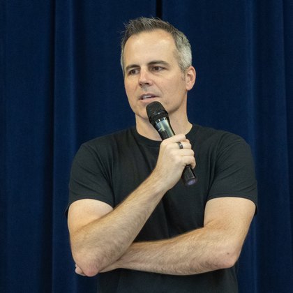 Chad Kempel, youth keynote speaker based in Boise, Idaho, on stage with a microphone