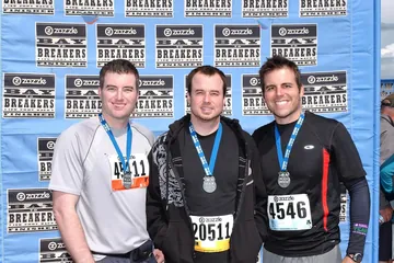 Chad Kempel, bib 4546, with his two brothers and their finisher medals at the 2011 Bay to Breakers