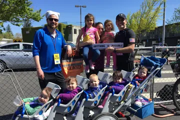 Chad Kempel and his family with the stroller after the 2019 Modesto Marathon record