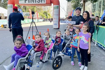 Chad Kempel and his family with the stroller at the Oakland half marathon record finish