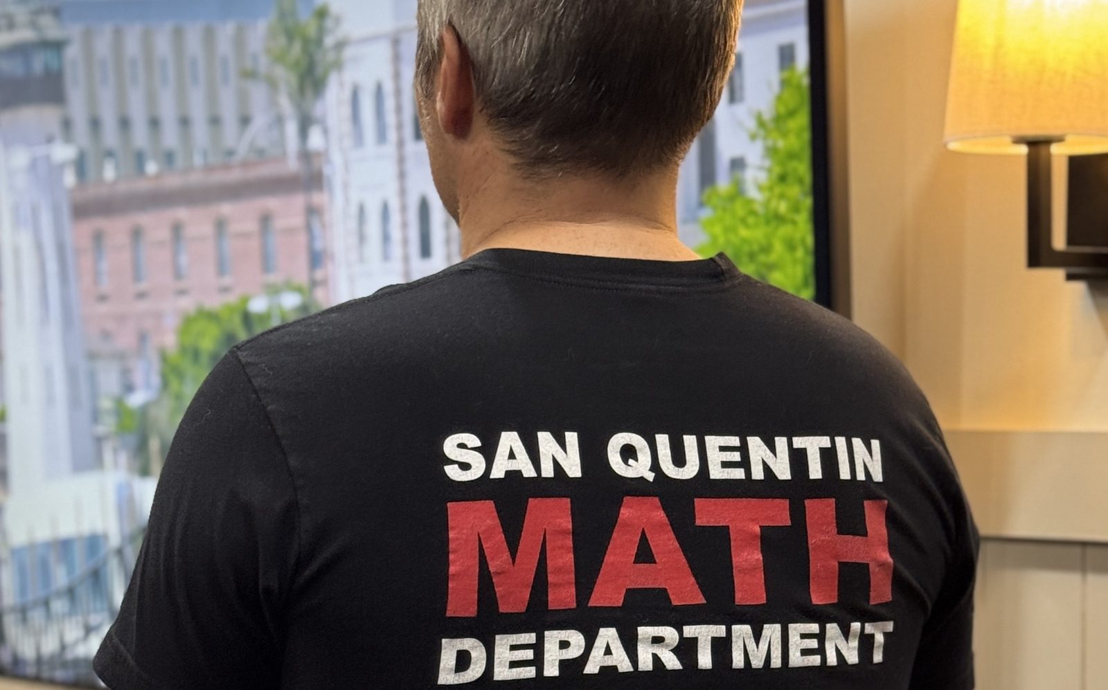 Chad Kempel, seen from behind, wearing his San Quentin math department shirt