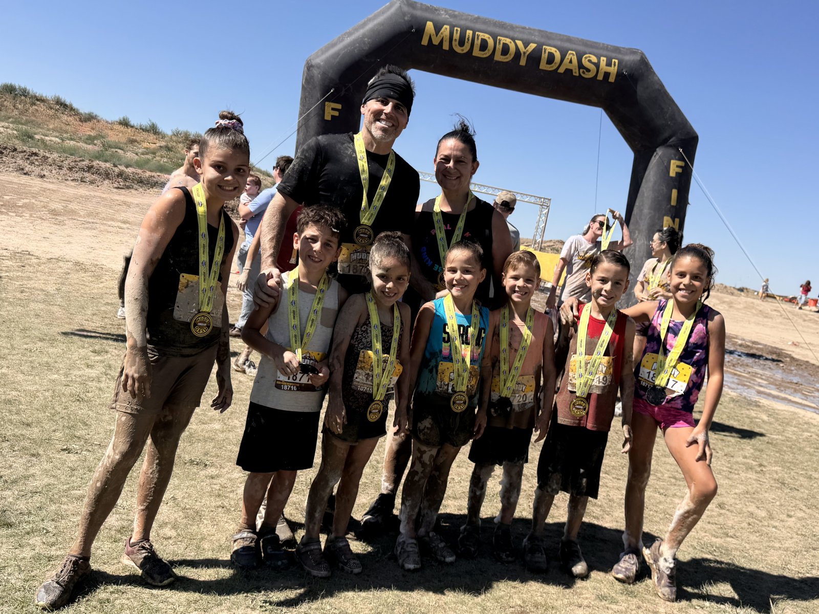 The Kempel family with medals after the Muddy Dash obstacle race