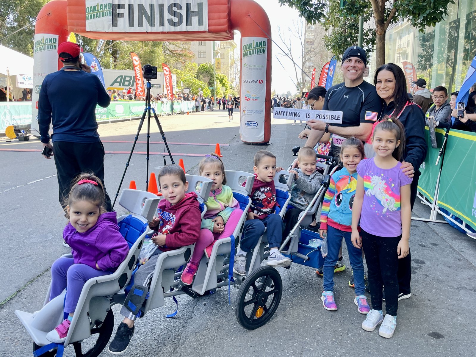 Chad Kempel and family at the Oakland Running Festival finish arch